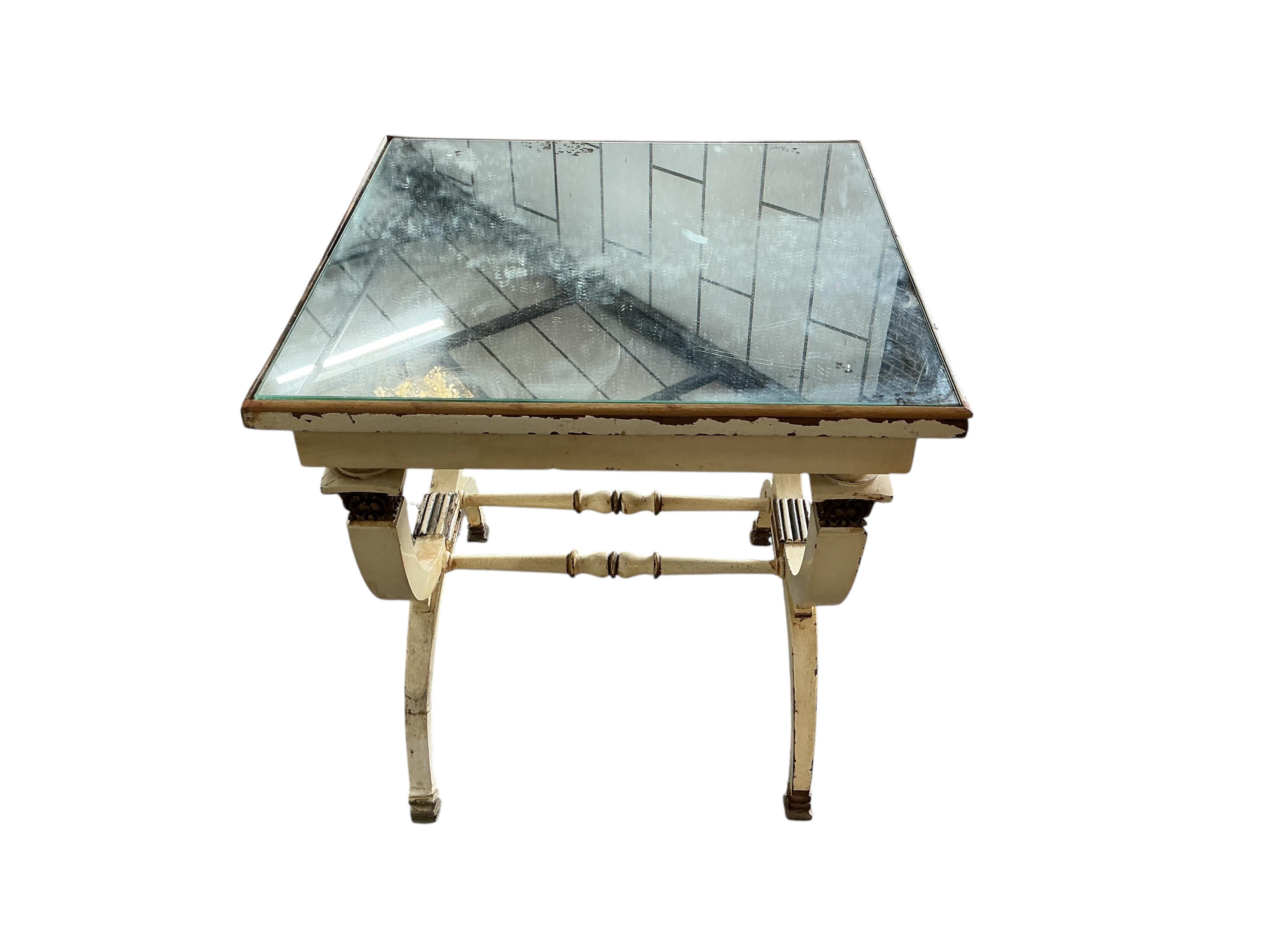A cream, gilt and mirrored X-framed occasional table, in Empire style, width 49cm, depth 49cm, height 52cm